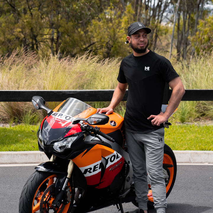 IXK Gear Cotton Tee in Black and Grey Slim Sweats. Bike in the background.