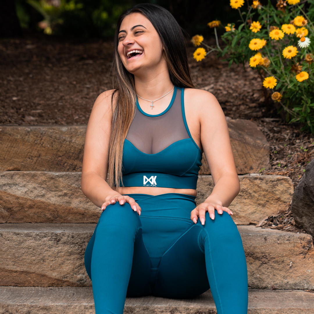 IXK Gear Mesh Sports Bra in Colour: Teal paired with NV Tights in Teal. Natural Background.