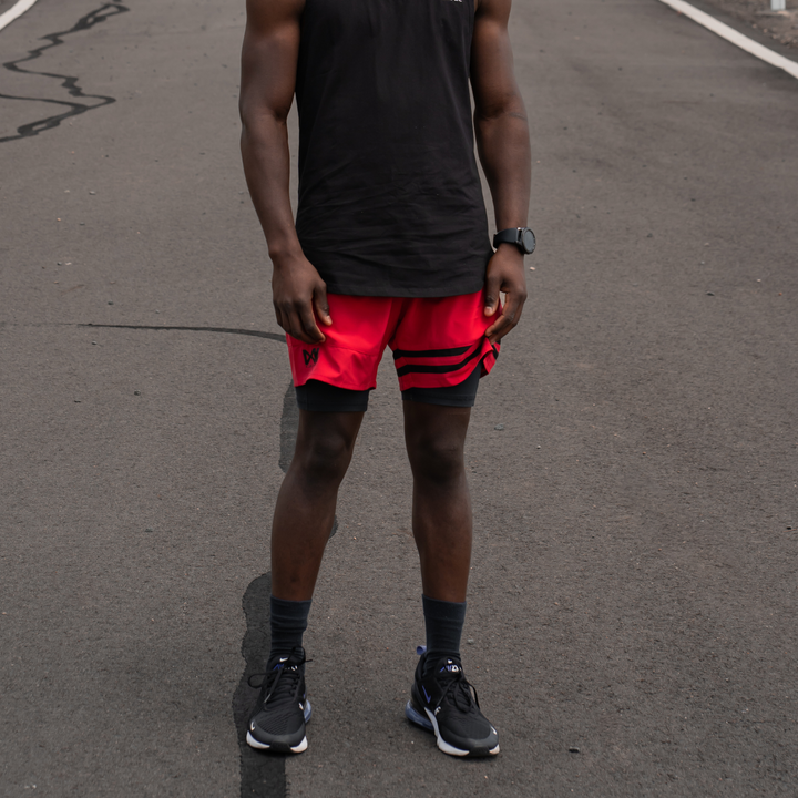 IXK Gear Quick Dry Accent Shorts in Colour: Red. Natural background. Paired with IXK Gear Muscle Tank in Colour: Black.