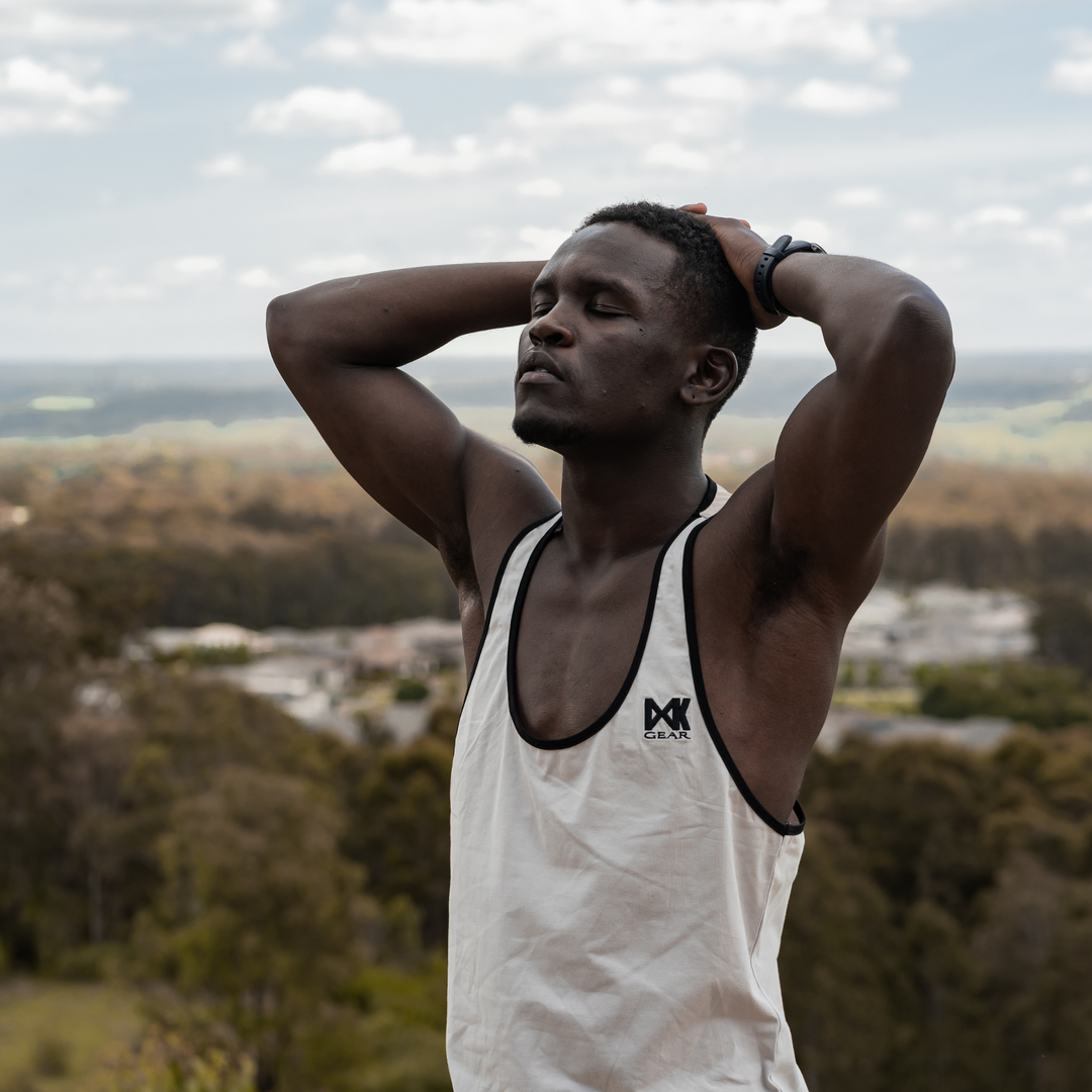 IXK Gear Gym Stringer Tank Top. Colour: Stone. Natural background.