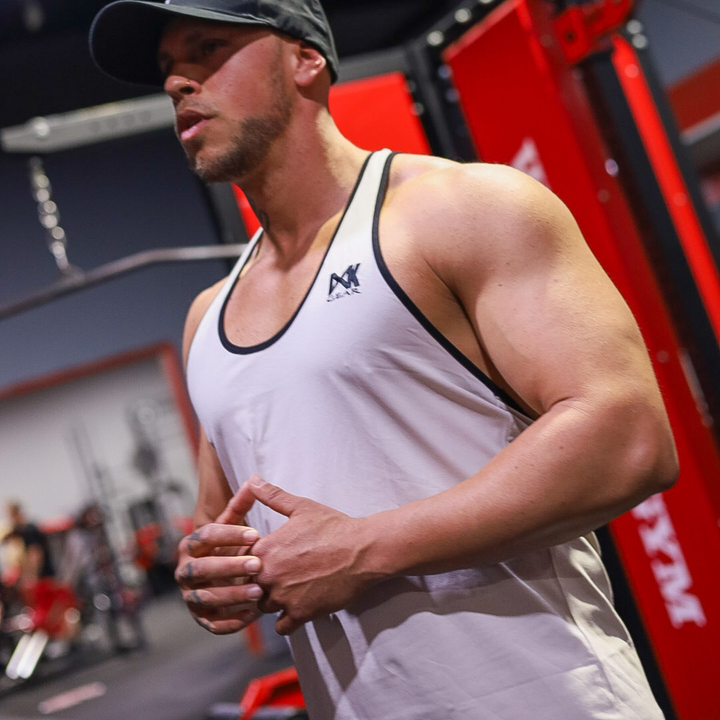 IXK Gear Stringer Tank Top in Colour: Stone. Gym Background.