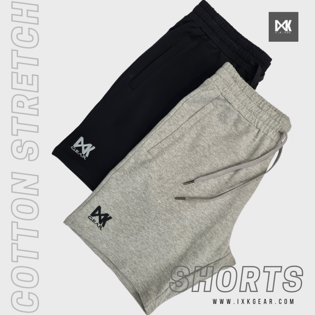 Flat lay of IXK Gear Cotton Stretch Shorts in Grey (pictured on top) and Black (pictured on bottom). Plan white background with text on the side and bottom of pciture.