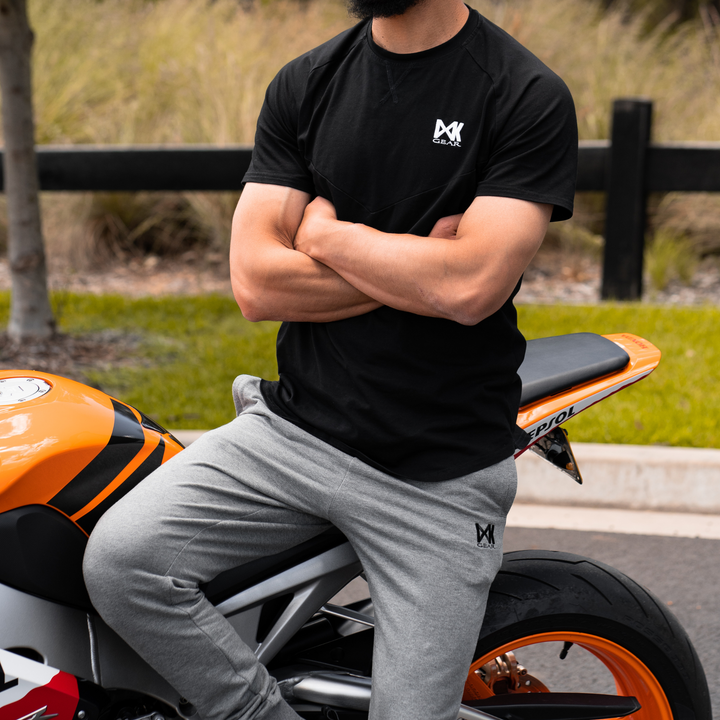 IXK Gear Cotton Tee in Black and Grey Slim Sweats. Bike in the background.