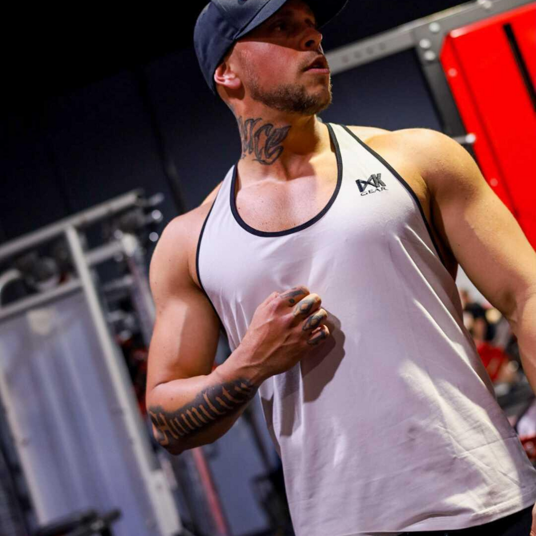 IXK Gear Stringer Tank Top in Colour: Stone. Gym Background.