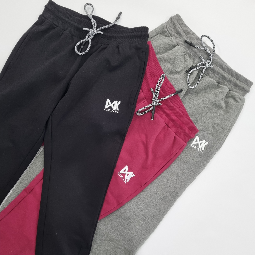 Flat lay of IXK Gear Womens Cropped Trackies in three colours (L to R): Black, Maroon and Grey. Plain white background,