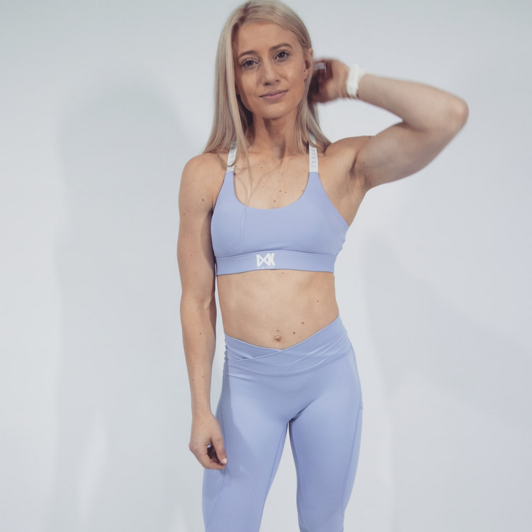 IXK Gear X Sports Bra in Colour: Lavender. Plain White Background. Model is also wearing NV Tights in Colour: Lavender.